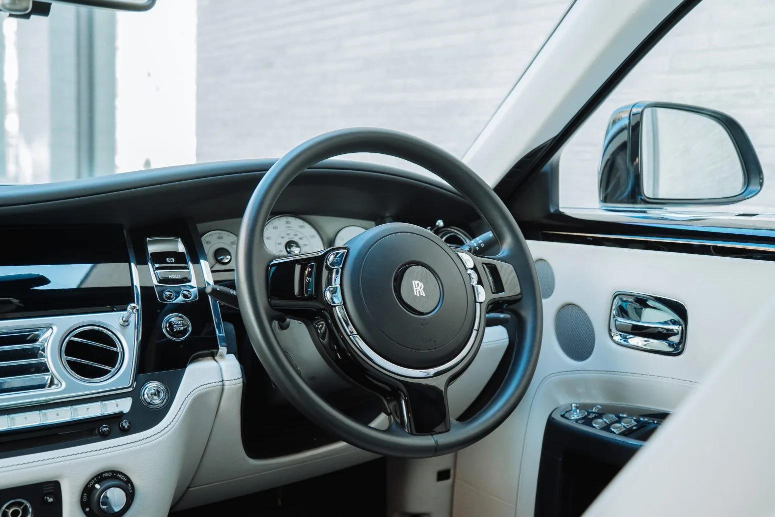 Luxurious white interior of AZ Luxe's Rolls Royce Ghost cockpit