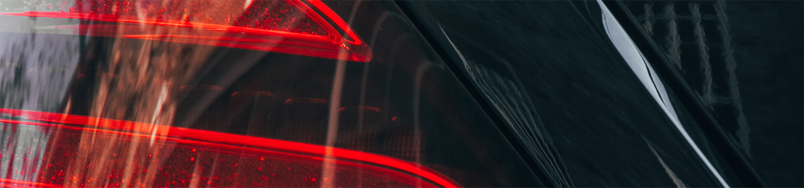 Close-up of sleek red tail lamp on AZ Luxe's Mercedes Benz S Class