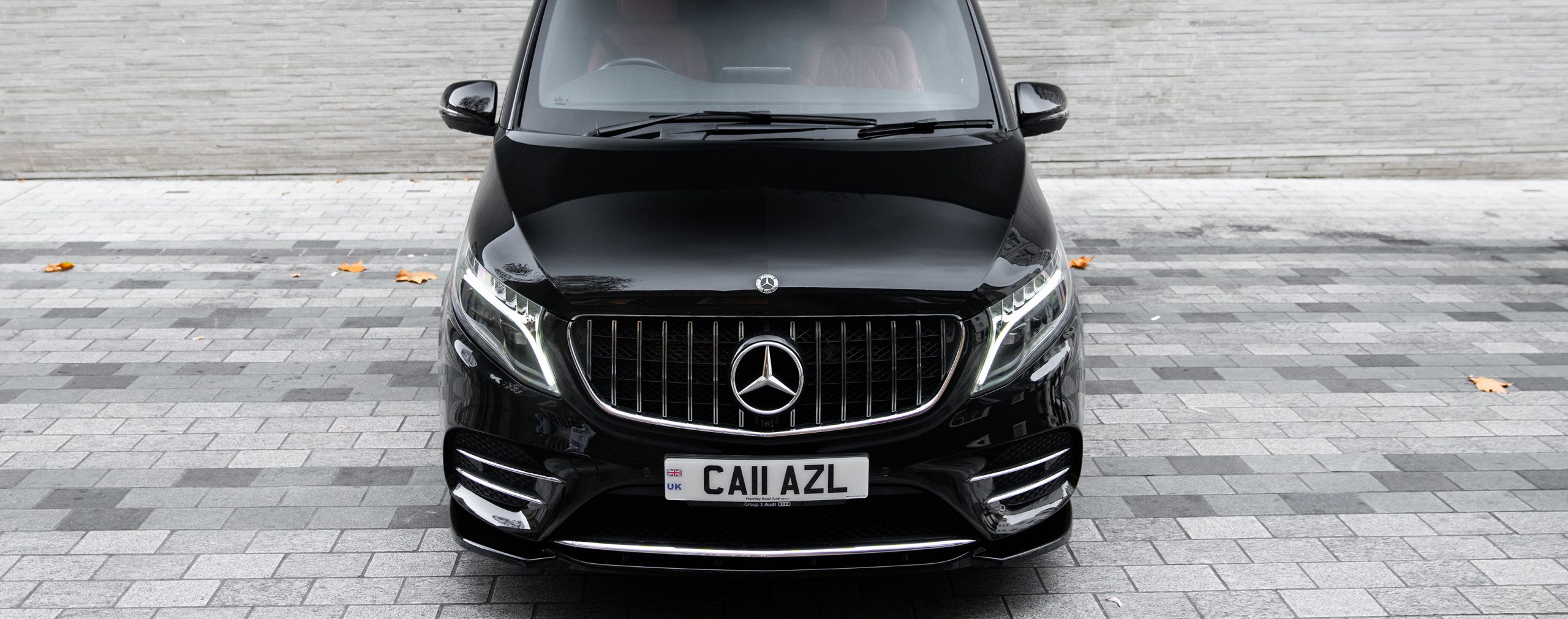 Imposing front view of AZ Luxe's black Mercedes Benz Land Jet, showcasing luxurious chauffeur service