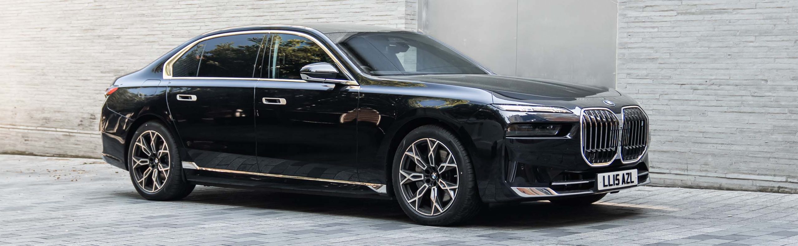 Sleek side view of AZ Luxe's all-electric BMW i7, showcasing its elegant design and zero-emission luxury