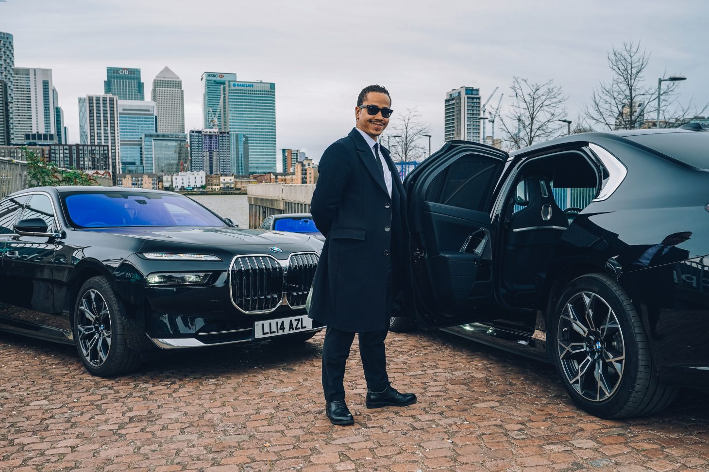 AZ Luxe's award-winning chauffeur Tony Hernandez with BMW i7 electric cars for Heathrow transfers