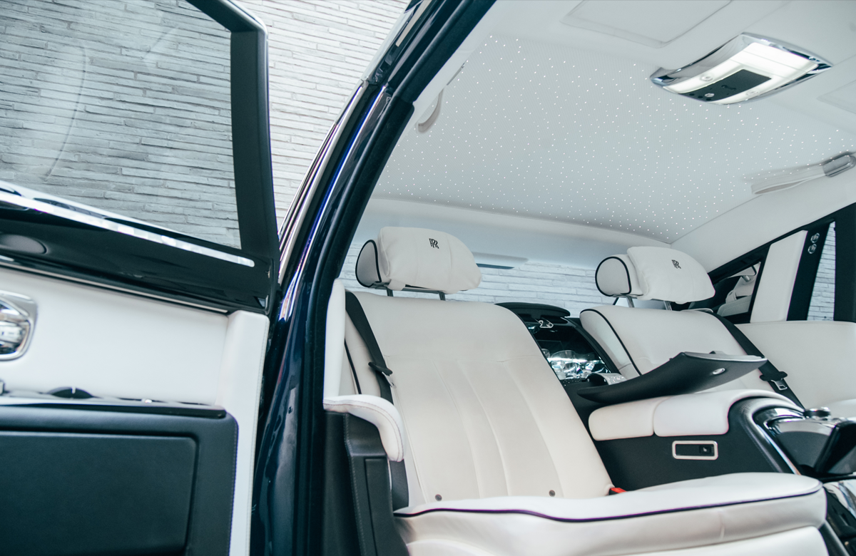 Bright interior view of AZ Luxe's Rolls Royce Ghost through open door