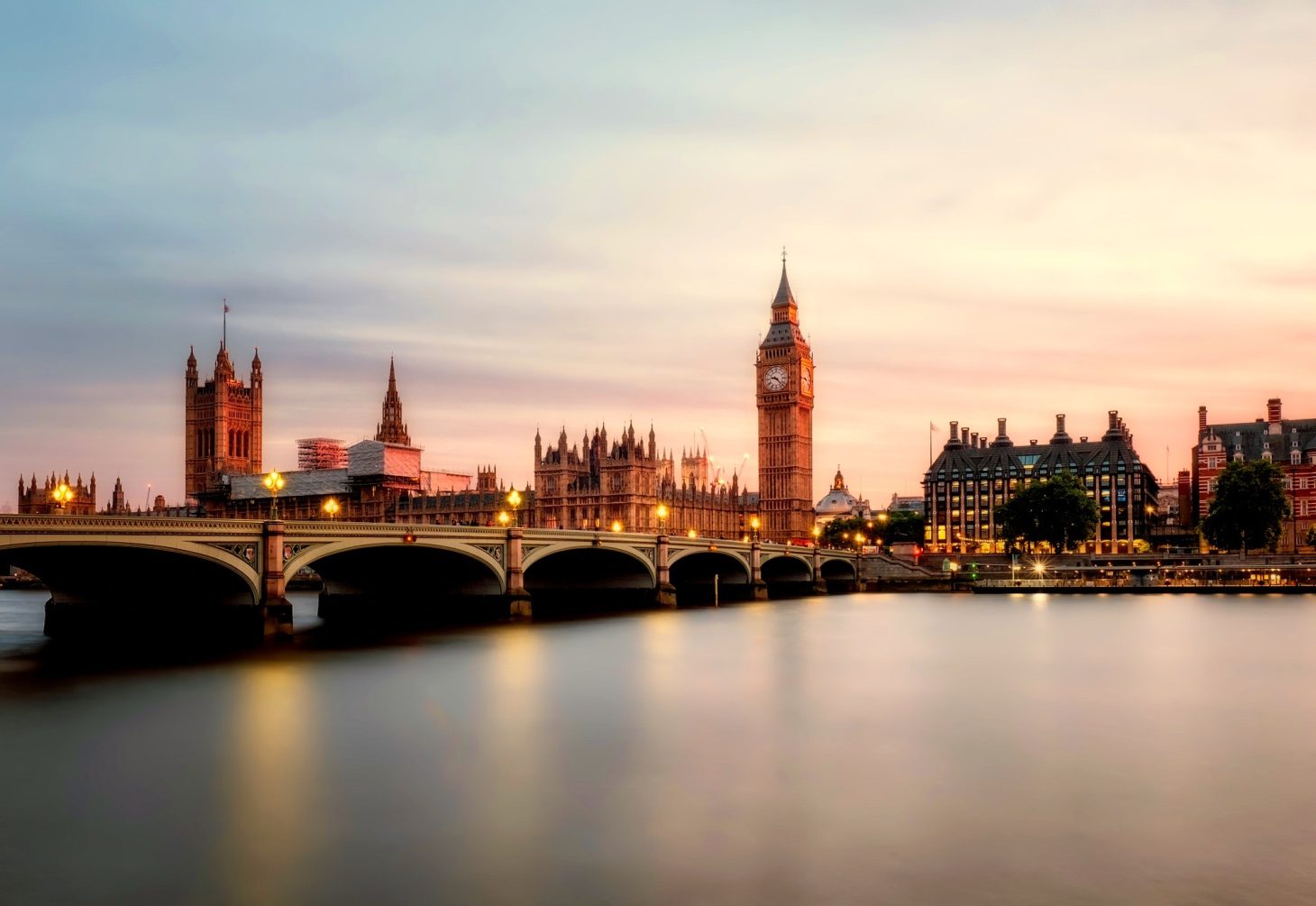 Illuminated view of Thames River, London Bridge, and Big Ben, highlighting AZ Luxe's concierge service area