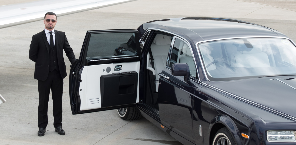 AZ Luxe chauffeur opening Rolls Royce Phantom door for customer at Heathrow