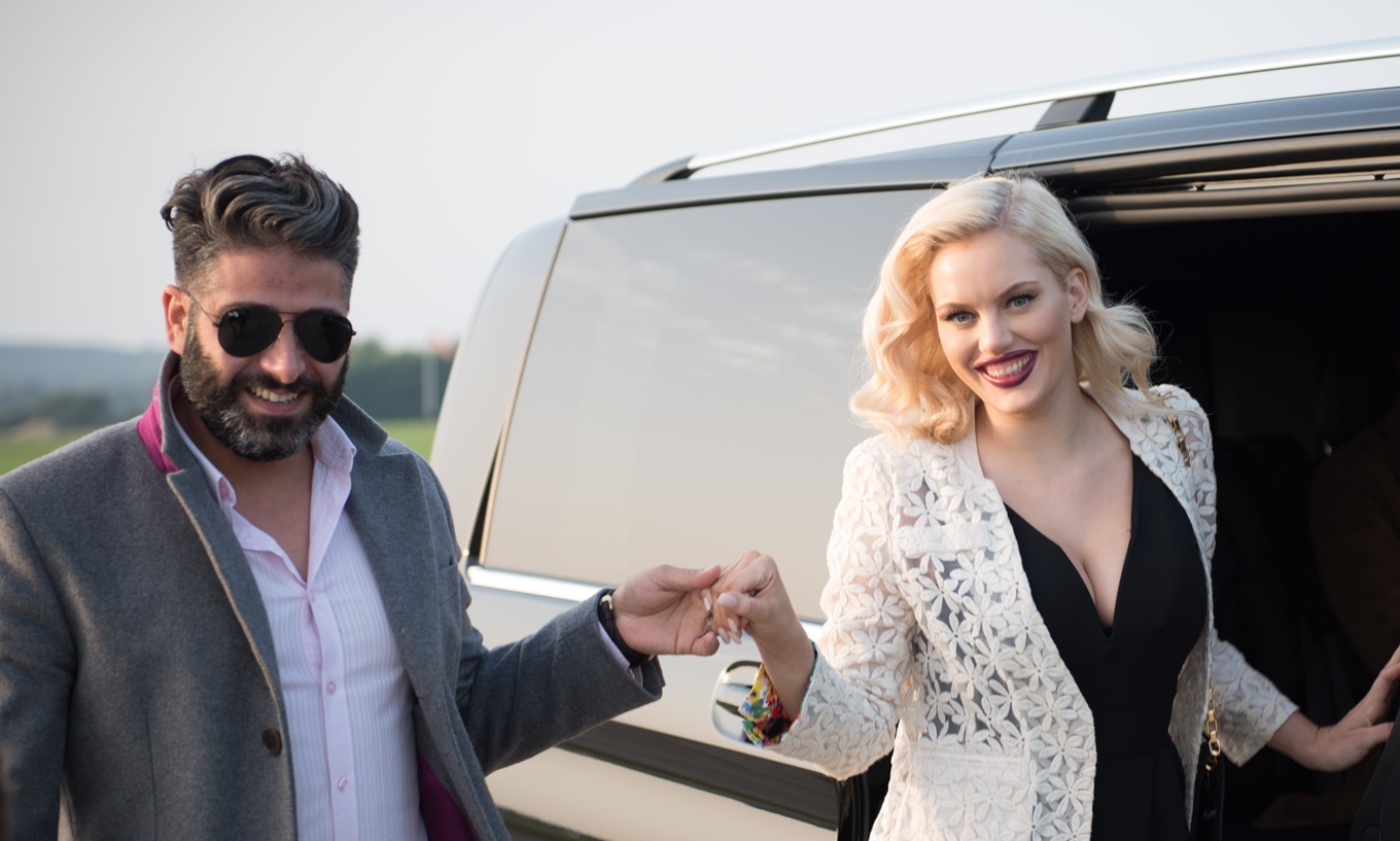 Couple deboarding AZ Luxe's Mercedes Benz V Class at airport, heading towards chartered flight