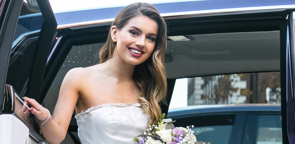 Elegant bride stepping out of AZ Luxe's Mercedes Benz S Class during wedding ceremony