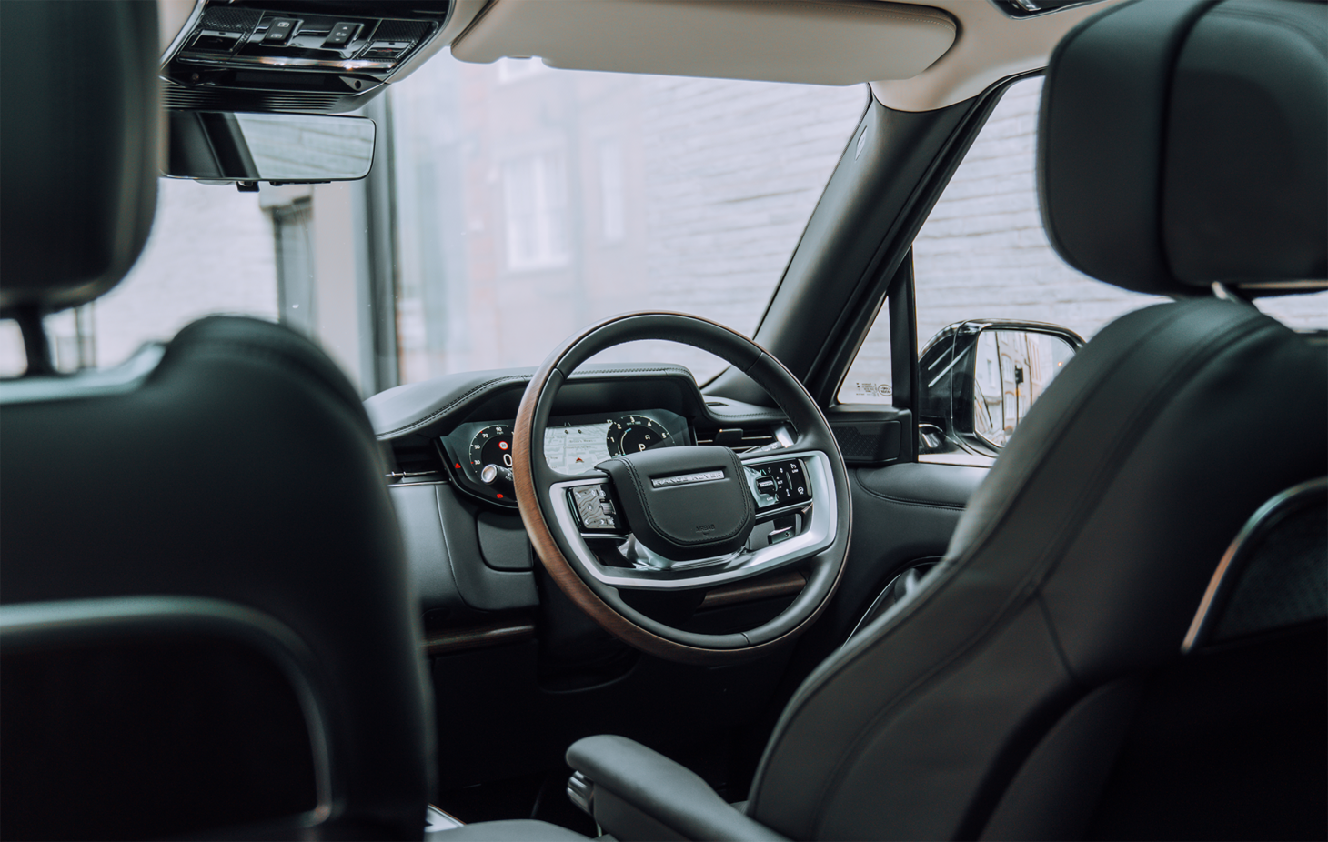 Range Rover's steering wheel, highlighting driver-focused luxury